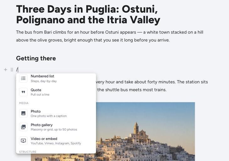 The slash menu scrolled to its Media group, showing Photo, Photo gallery and Video or embed