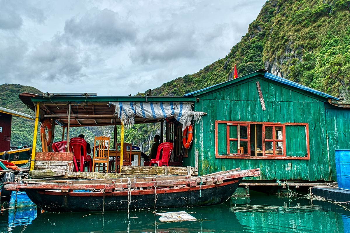 green wooden house on the sea