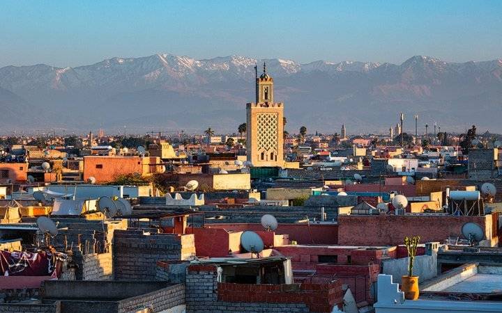 The Atlas Mountains rise behind the city of Marrakech