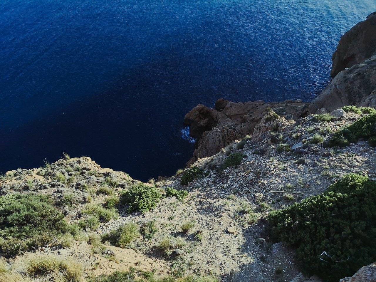   At the point, where Albir lighthouse was built, the height of the cliff facing the sea is about 112m. Photo by Alis Monte [CC BY-SA 4.0], via Connecting the Dots