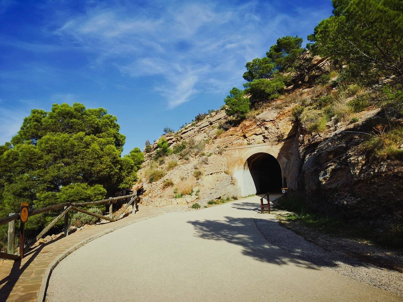   The next thing to catch your attention, undoubtedly, is going to be a tunnel, built here 60 years ago to make the access to 156-year old Albir lighthouse less dangerous. Photo by Alis Monte [CC BY-SA 4.0], via Connecting the Dots