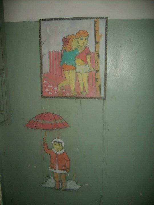 pictures on the walls of the abandoned school