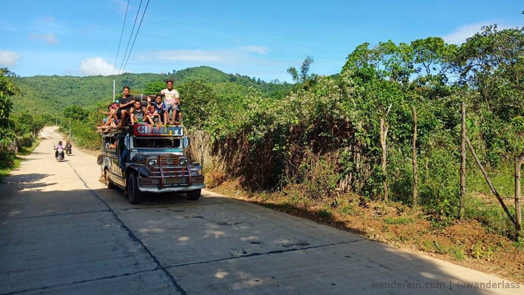 Toploading on a Jeepney. Friendly locals wave at us