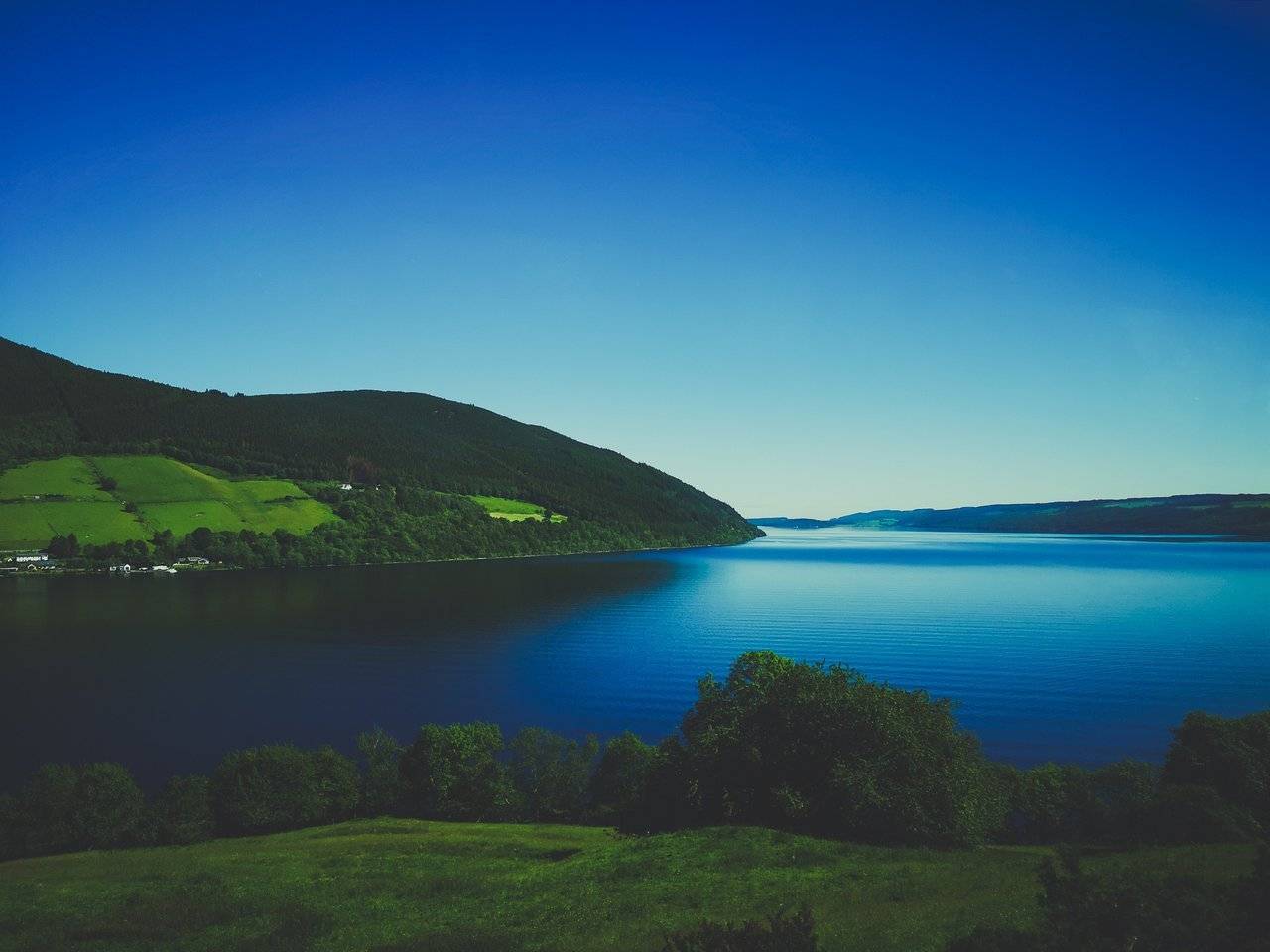   Loch Ness surounded by hills on a sunny day, Highlands of Scotland. Photo by Alis Monte [CC BY-SA 4.0], via Connecting the Dots