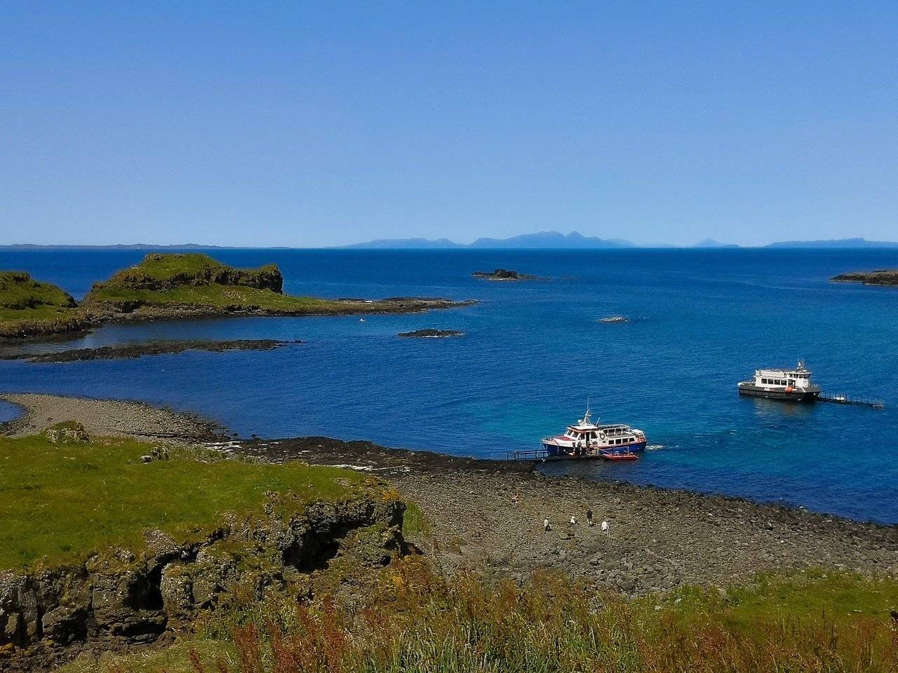 The treshnish Isles wildlife tour ships near a shore of Lunga island, Scotland