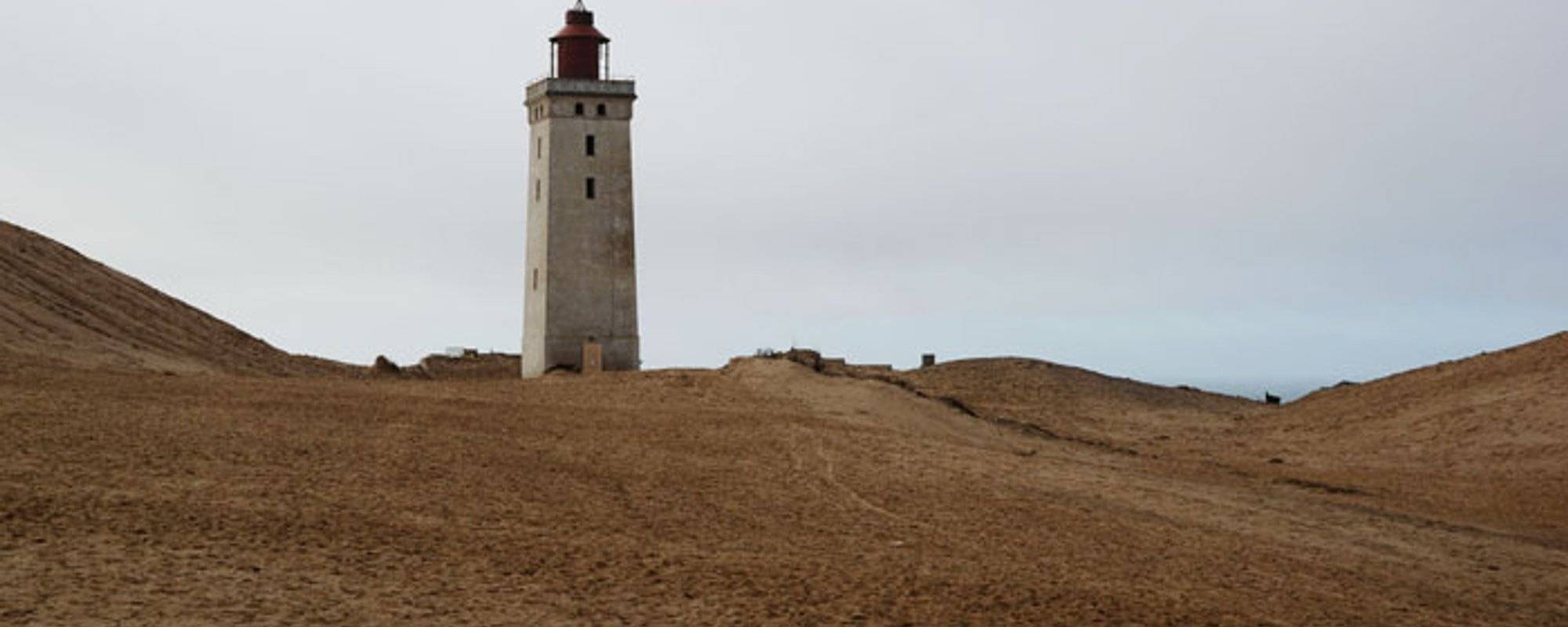 Denmark – A lighthouse standing on the edge, waiting to slip into the sea