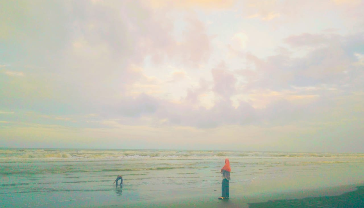 Seen A Woman Looking At A Small Child Who Playing Water In The Coastal Area