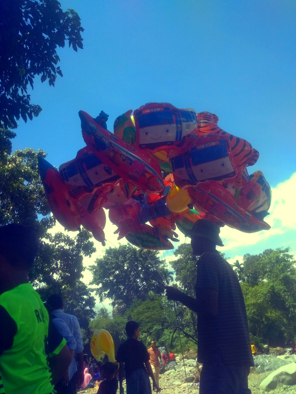 a kite seller is seen peddling his wares,