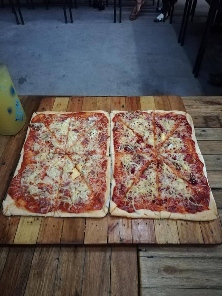 A couple of ham and cheese pizzas (sliced to 8 pieces each)