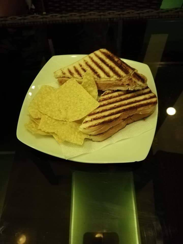 Toasted ham and cheese sandwich with chips