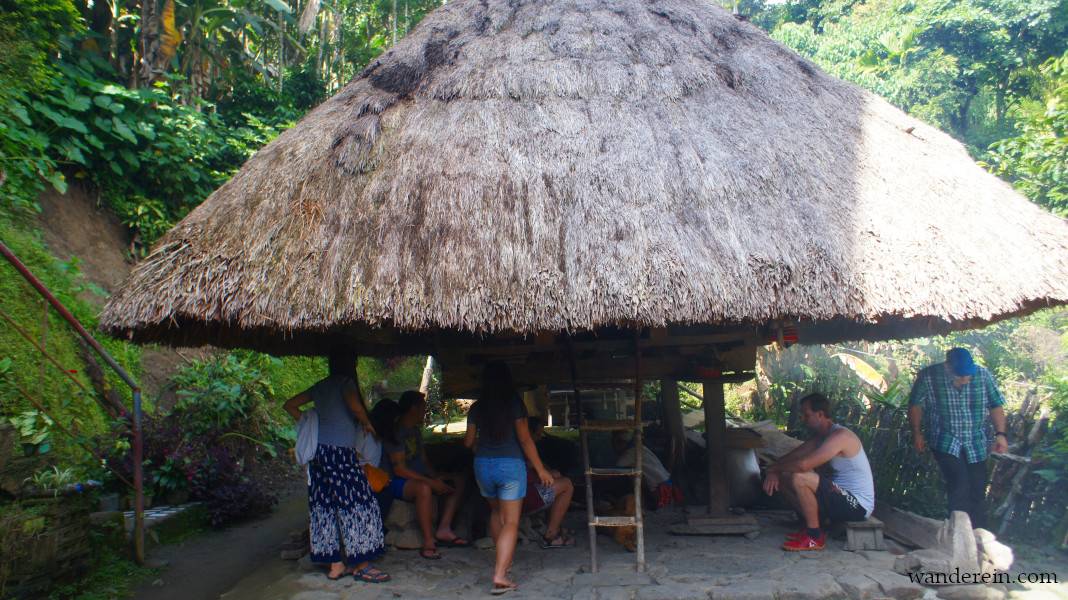 Guests at Mang Ramon's Homestay watch the rice wine preparation