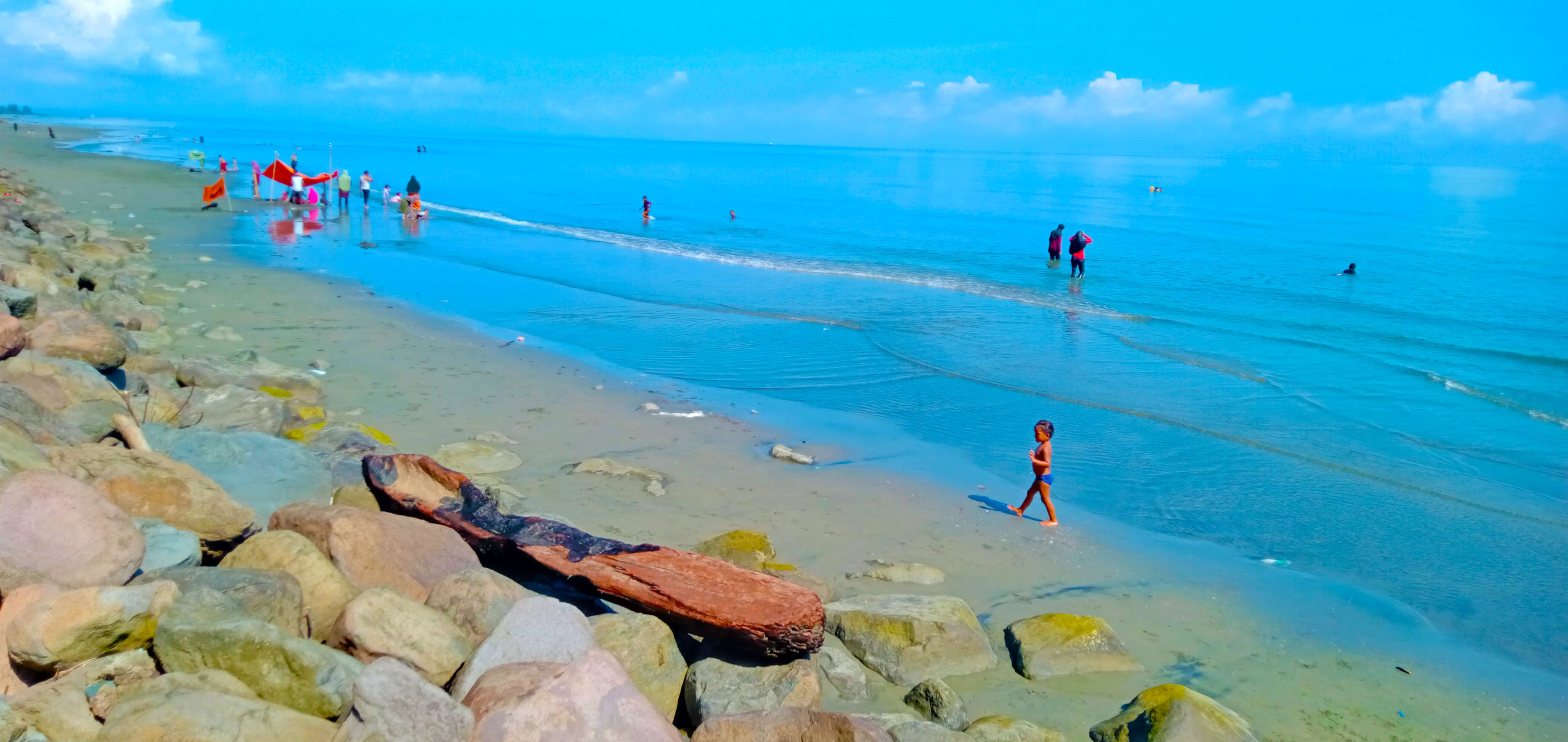             ```Little children and rocks on the beach