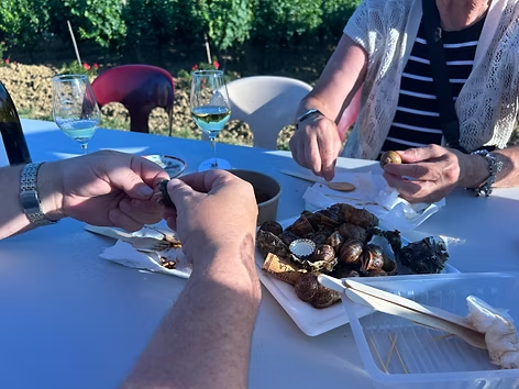 My husband and mother-in-law devouring a heaping bowl of escargots à la catalane