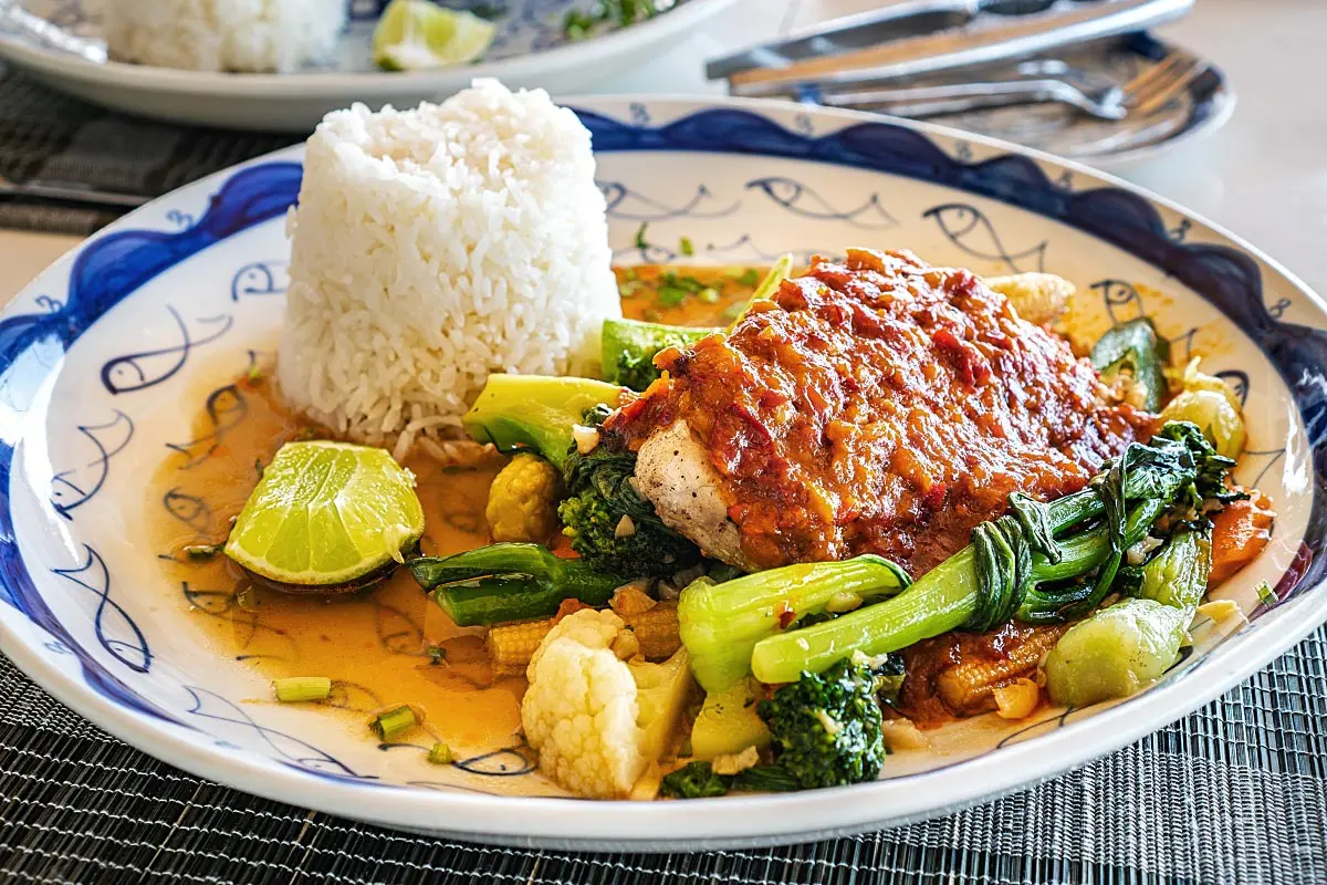 Snapper with Khmer spiced coconut sauce and garlic steamed vegetables.