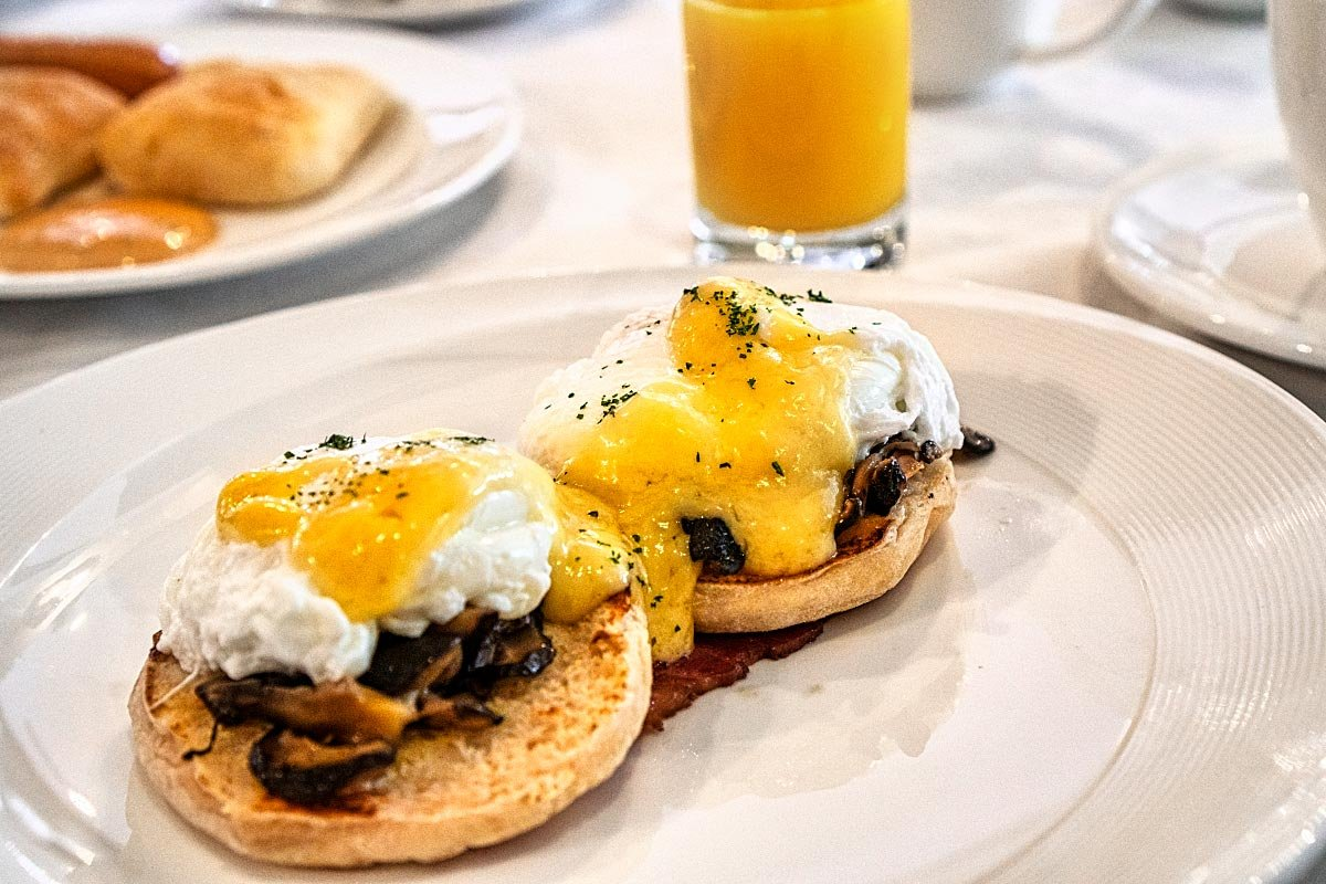 Free-range eggs benedict with mushrooms and Hollandaise sauce.