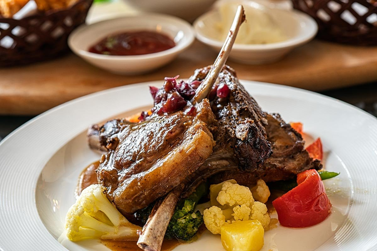 Lamb cutlets with slow-roasted vegetables and balsamic mustard reduction.