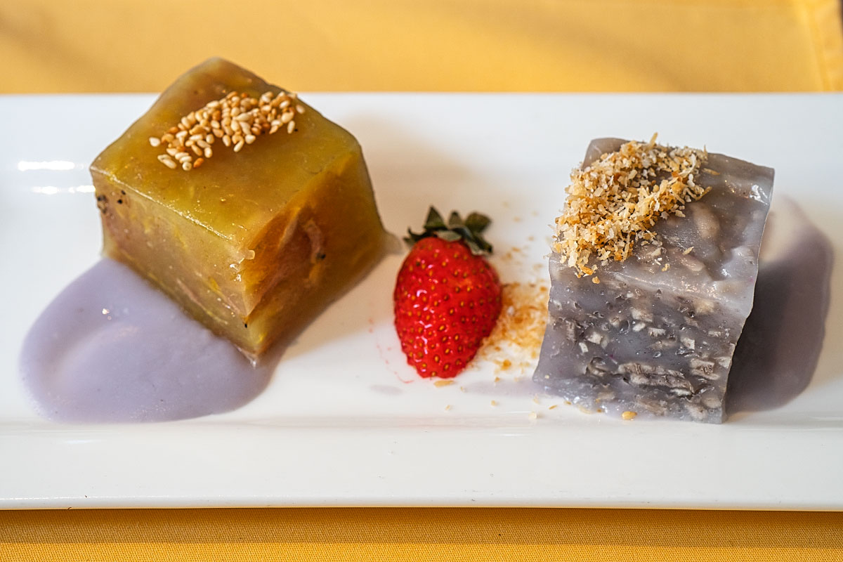 Piece of coconut and taro cake with a strawberry in between