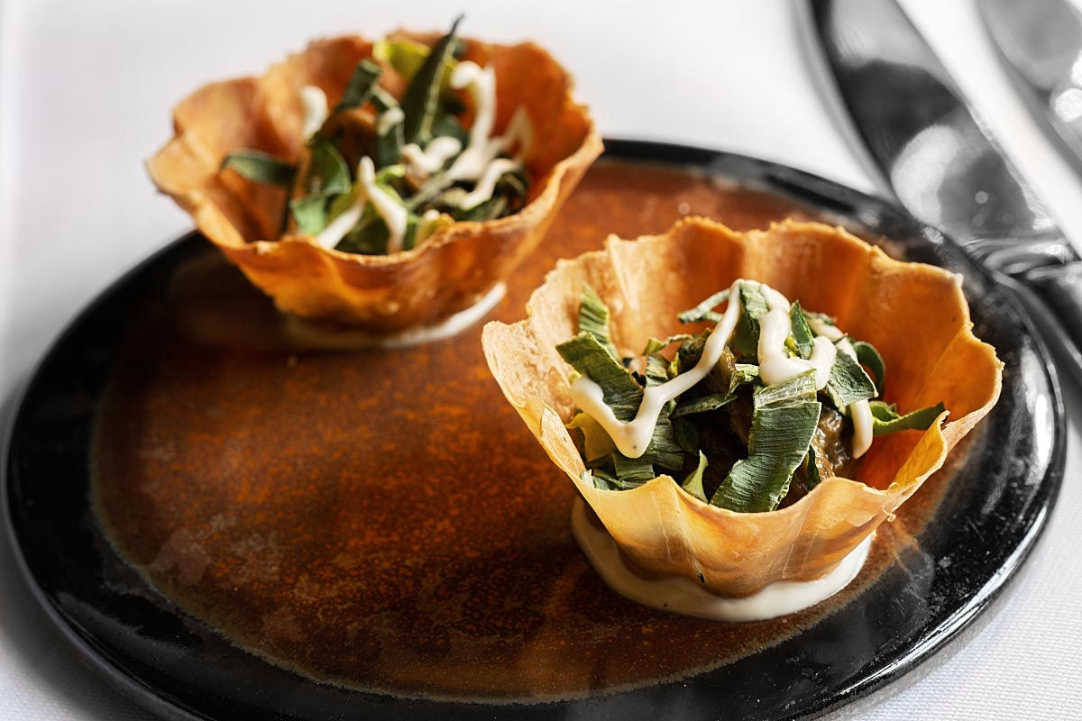 Paper-thin shell filled with leek paste, dry leek, and aioli