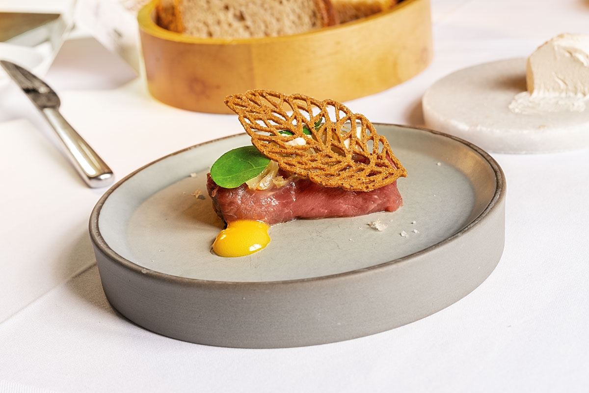 Beef tartare with kimchi, egg yolk and buckwheat cookie