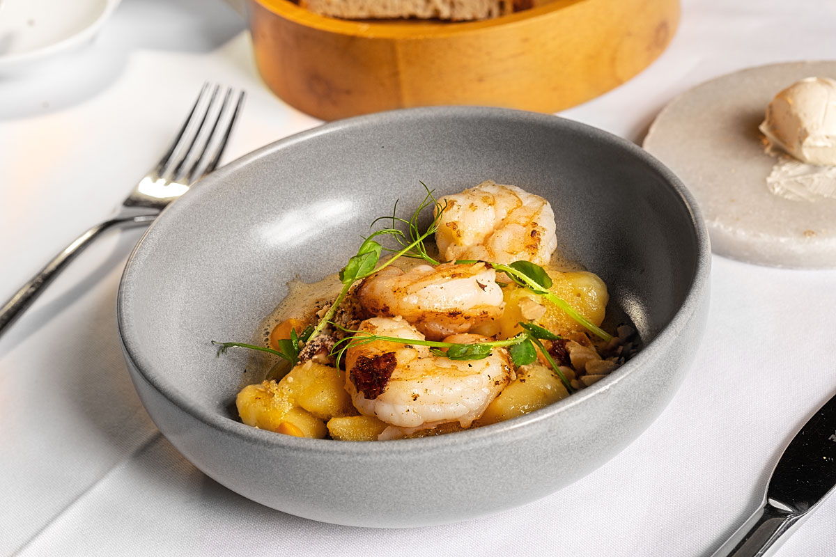 Succulent prawns with gnocchi, pumpkin puree, orange and walnuts
