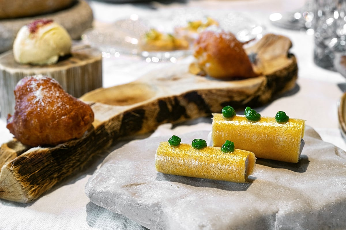A chilled corn roll filled with sheep albumin curd and fragrant black trumpet powder.
