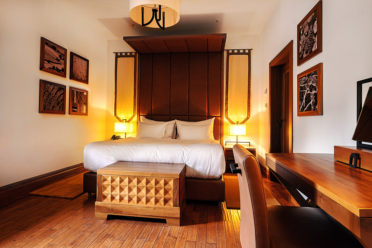 Warm wood, white linen and soft lighting give the Junior Suite its understated elegance.