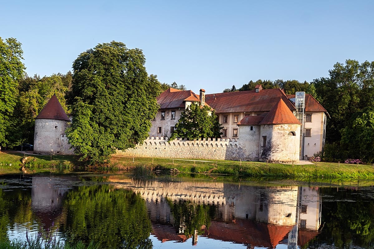 Otočec Castle stands on a small island in the Krka River, creating an unforgettable approach to the restaurant.