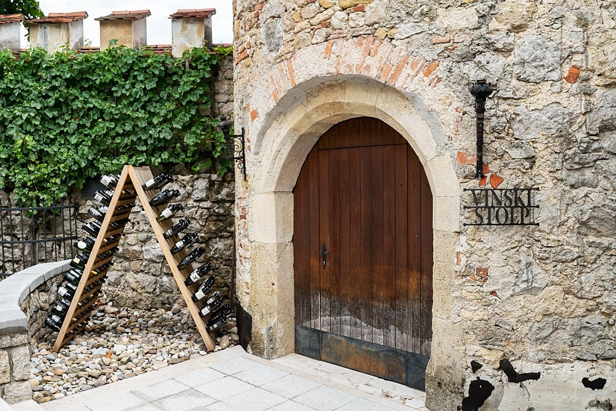 A stone arch marked Wine Tower leads into the castle’s dedicated tasting room.
