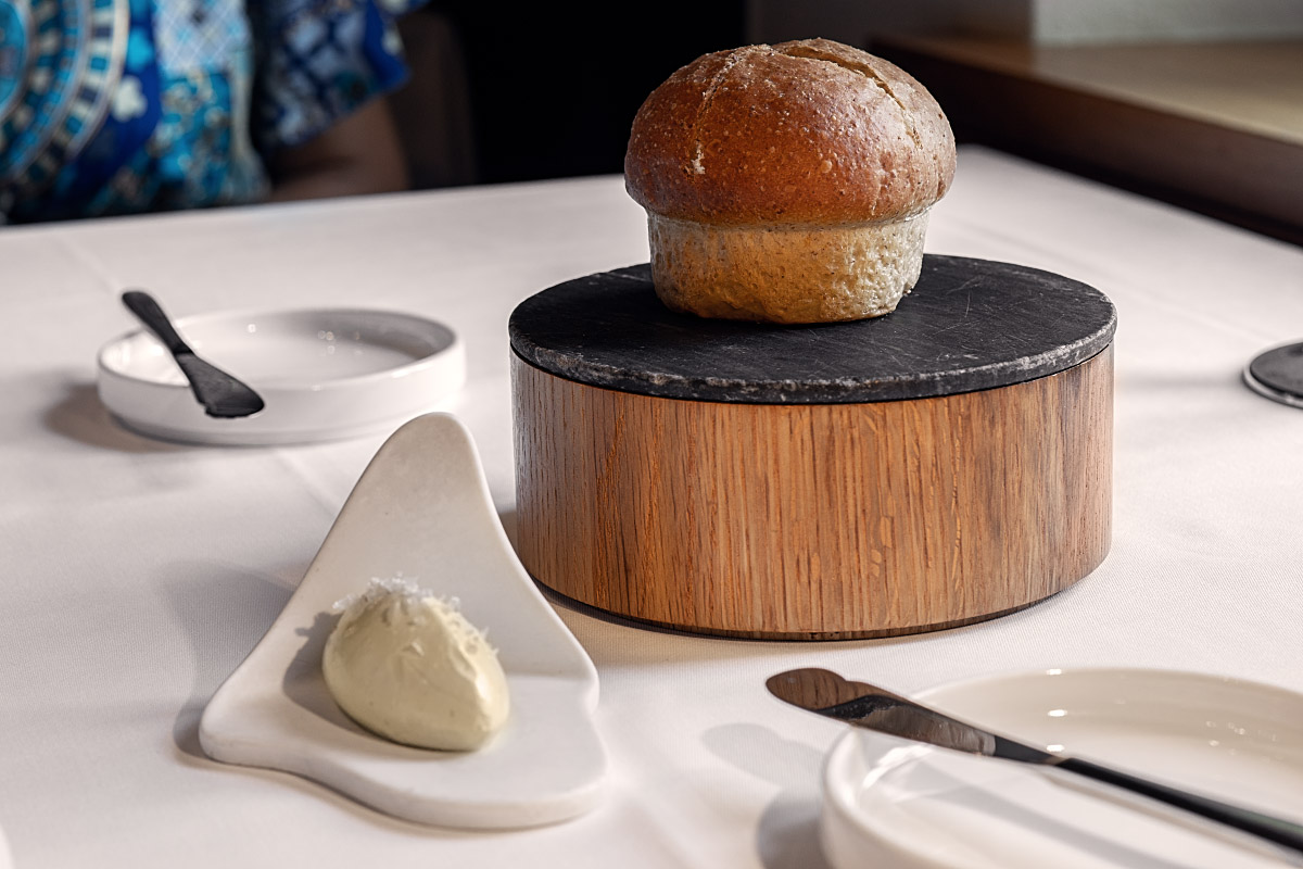 Warm whole-grain bread arrived on a raised slate with a generous quenelle of whipped butter.