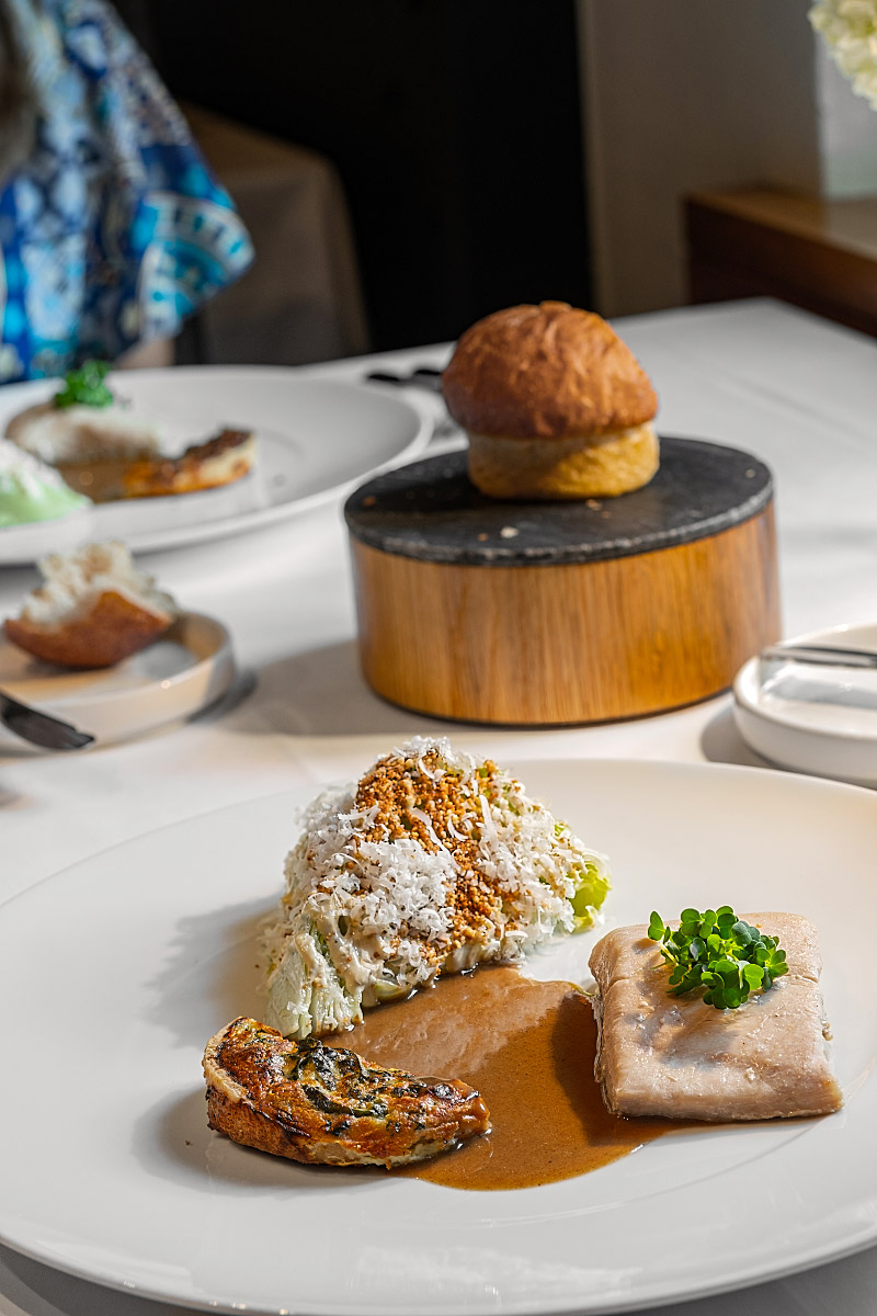 Tender confit sturgeon was served with crisp spinach and curd cheese pie and a savory sauce.