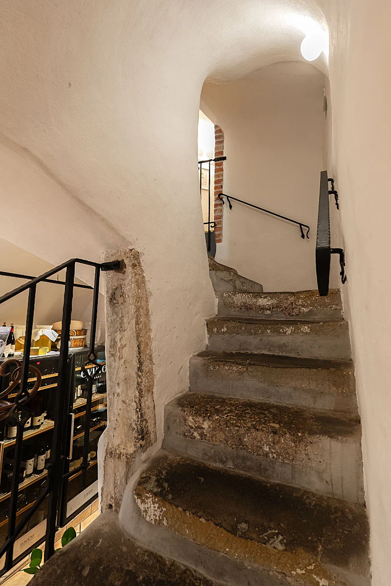 The old staircase gives the house a sense of age without turning dinner into a museum visit.
