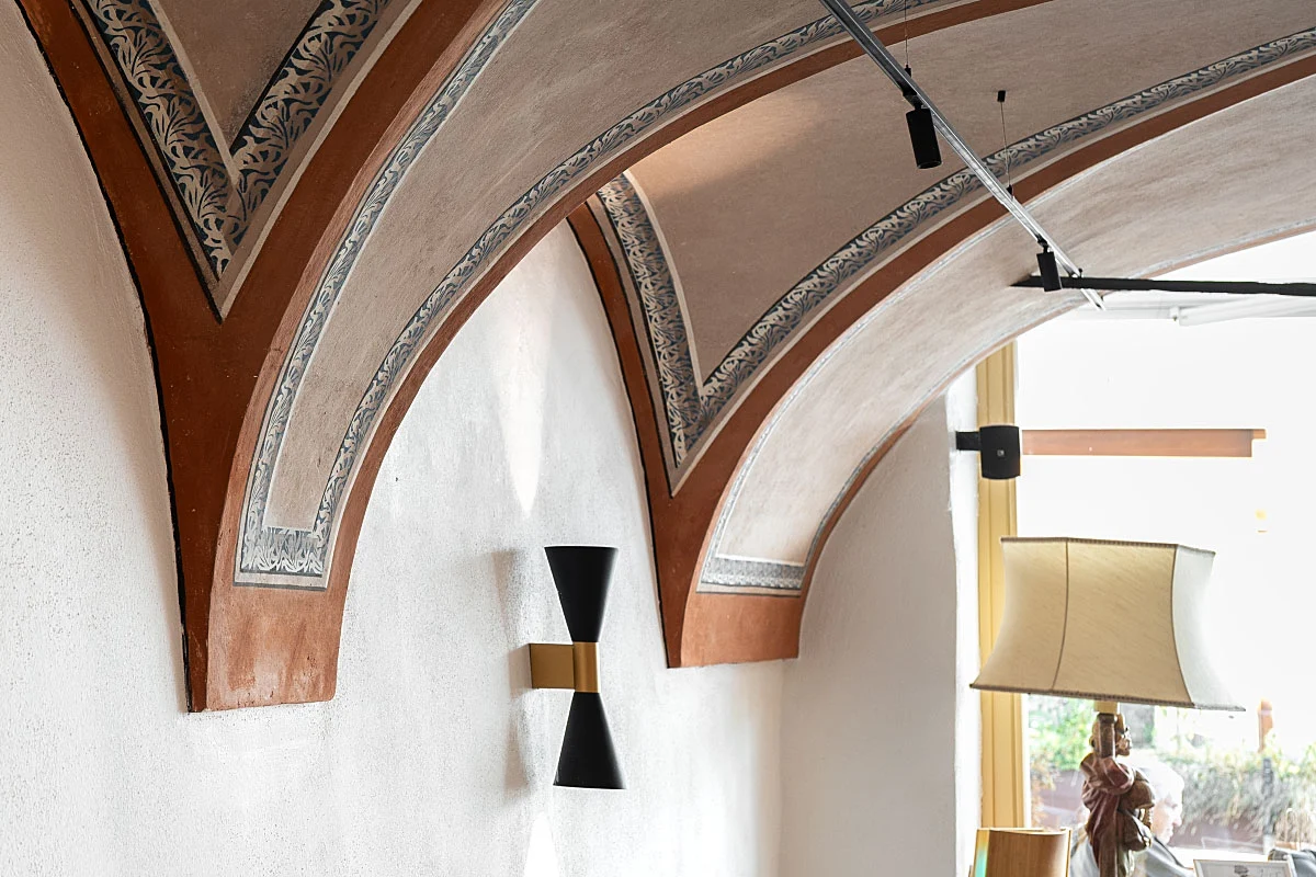 The painted ceiling is worth looking up from the plate for a moment.