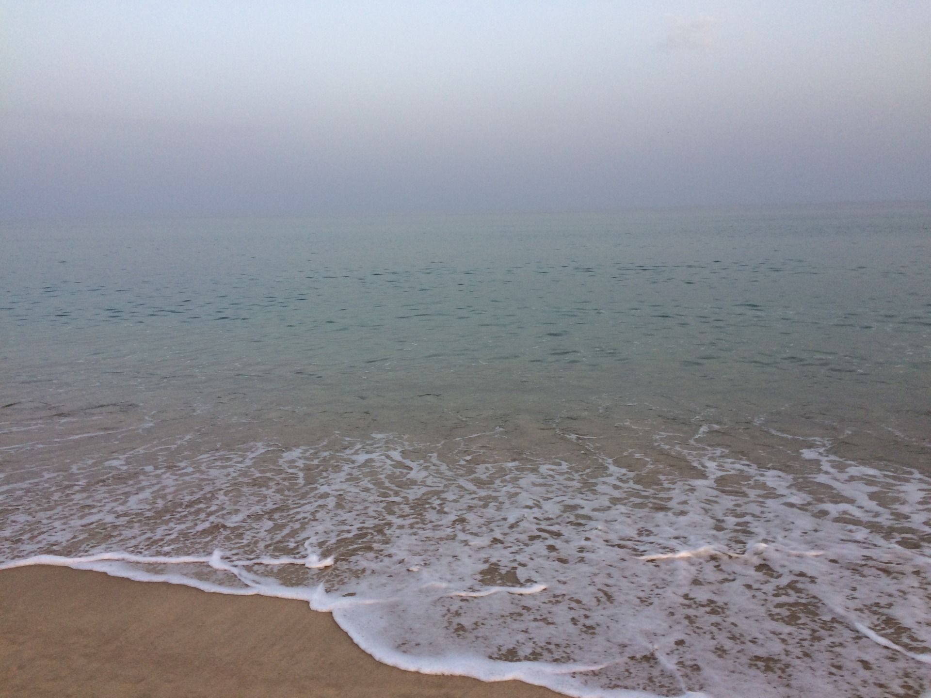 The wide ocean was calm in August, off Culatra island