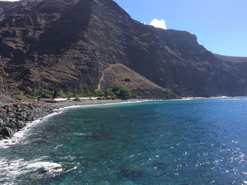 Rocky shore along the bay. The meditation center on the left.