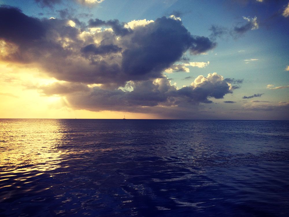 A sailboat heading out into the night. Wallilabou Bay, SVG, Eastern Caribbean 