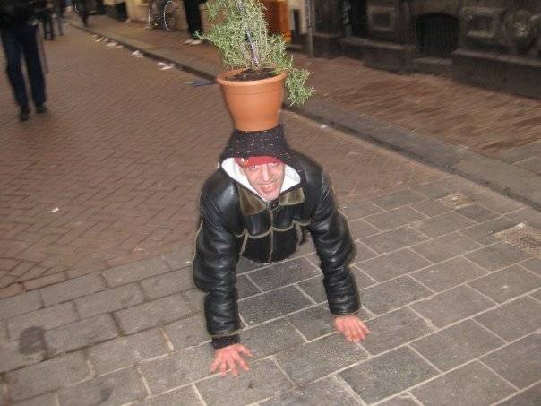 A guy doing push-ups with a plant pot on his head. Because, why not.