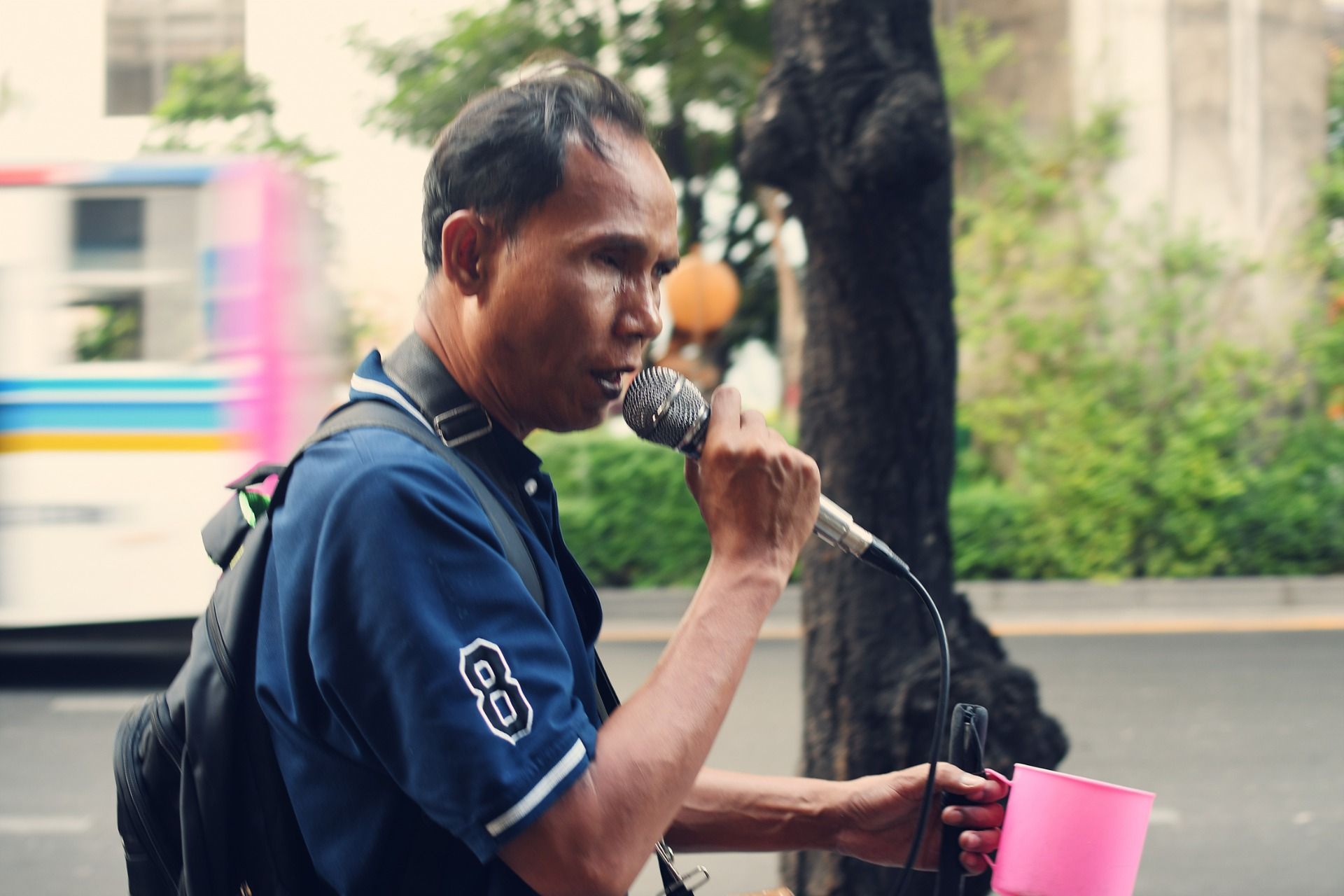 A blind man sings for donations