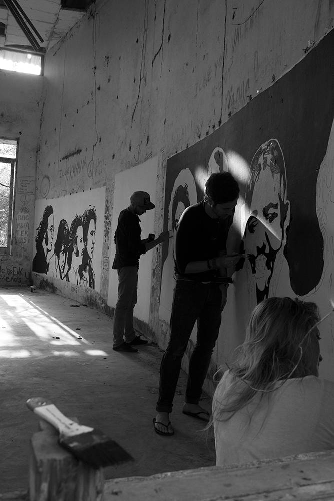 Artists touch up the mural.