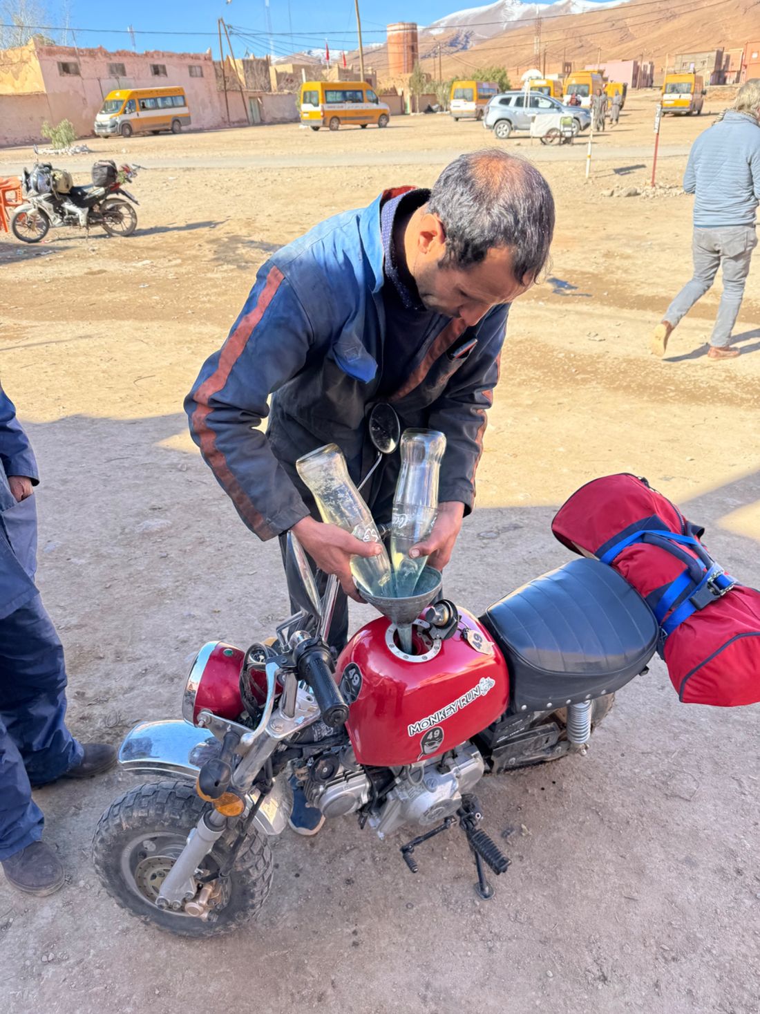 Mechanic giving me two liters of fuel.