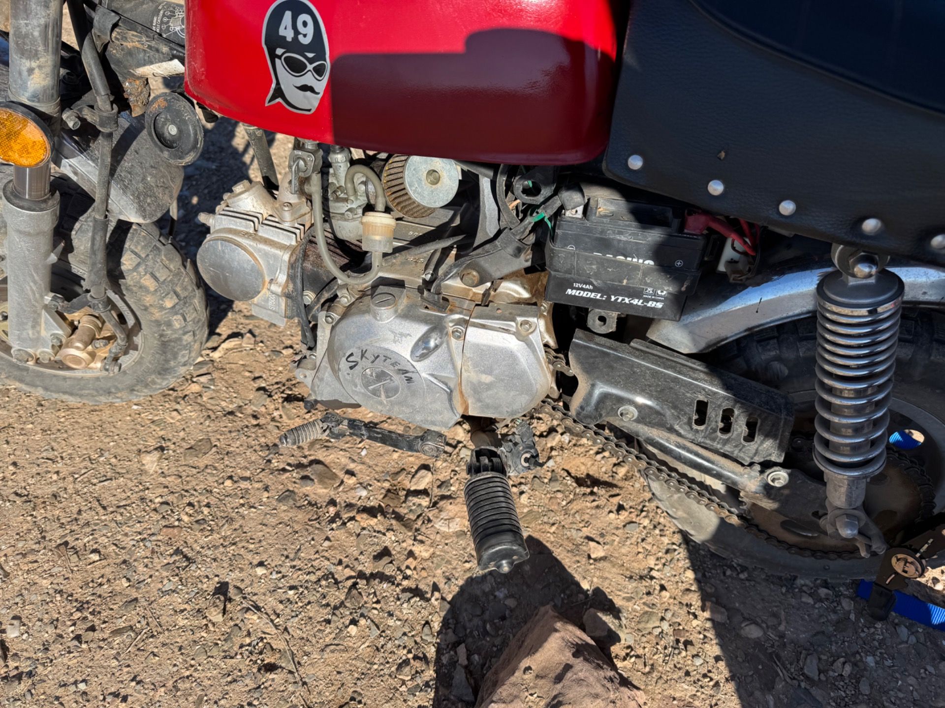 Kickstand gone, piece kept in place with zip tie. Gear shift also a bit warped.