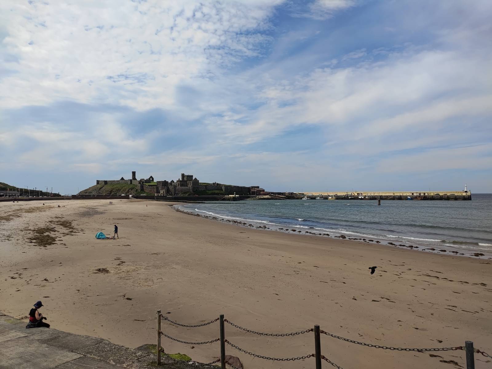 View of Peel beach, with Peel castle and pier in the background