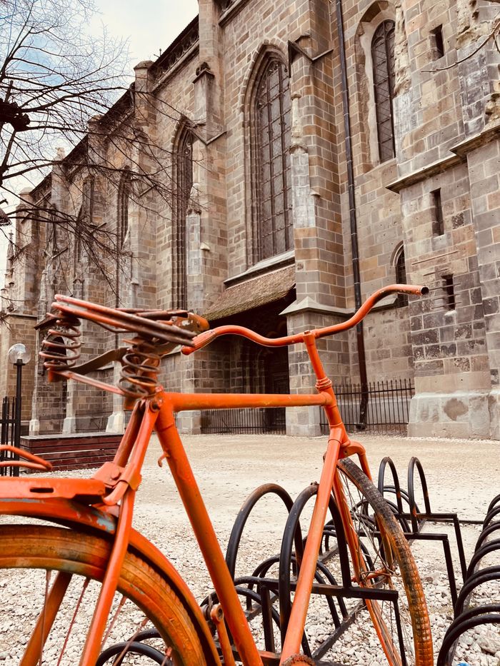 Broken orange bike in front of the Black Castle