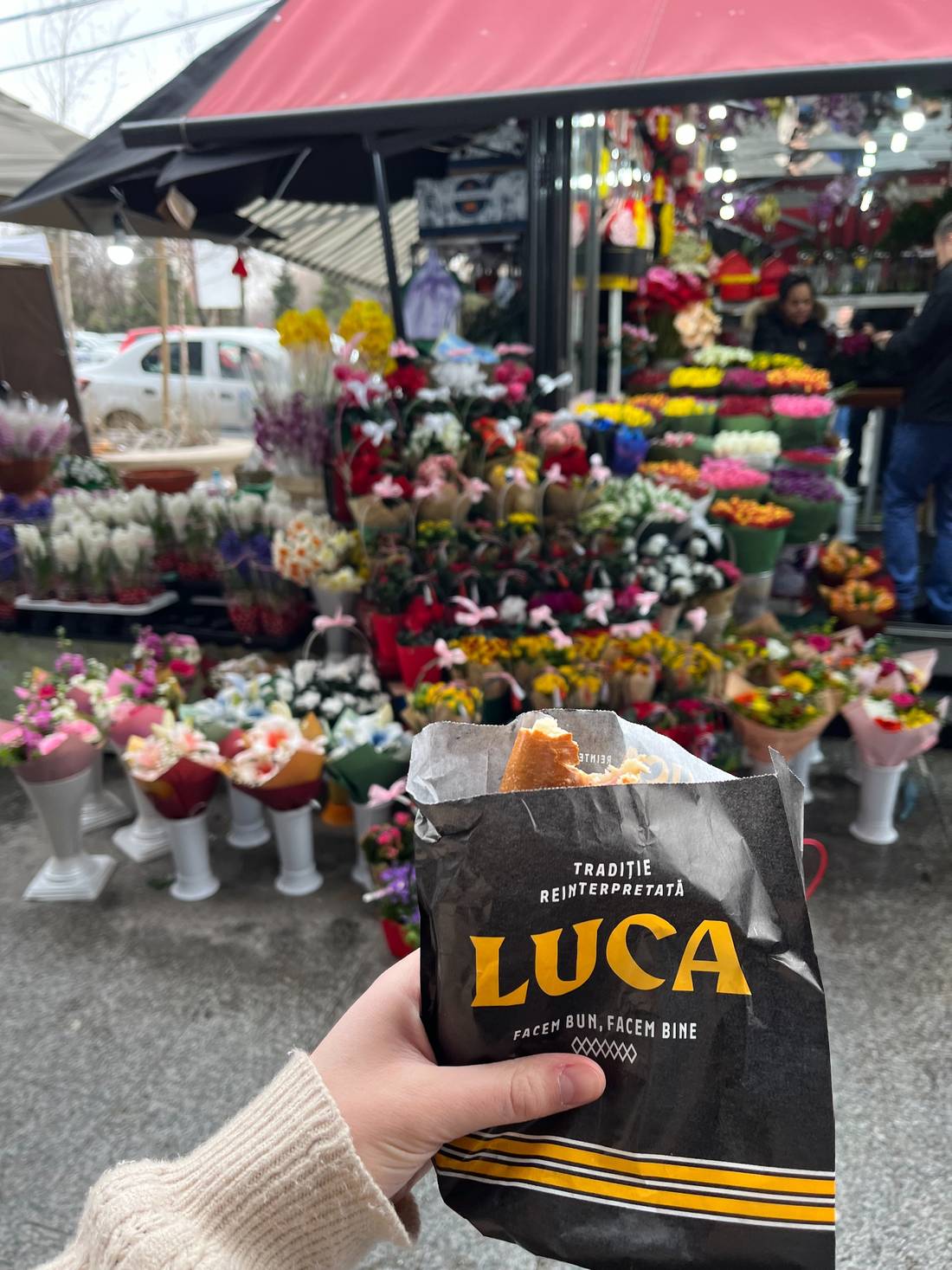 Luca food backdropped by one of the many, many Martisor flower vendors