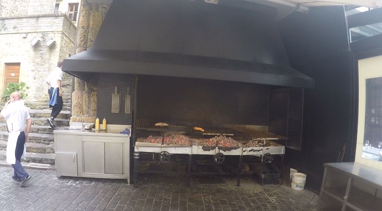 Fresh fish being grilled on embers at the Kaia-Kape restaurant, in Katrapona square.