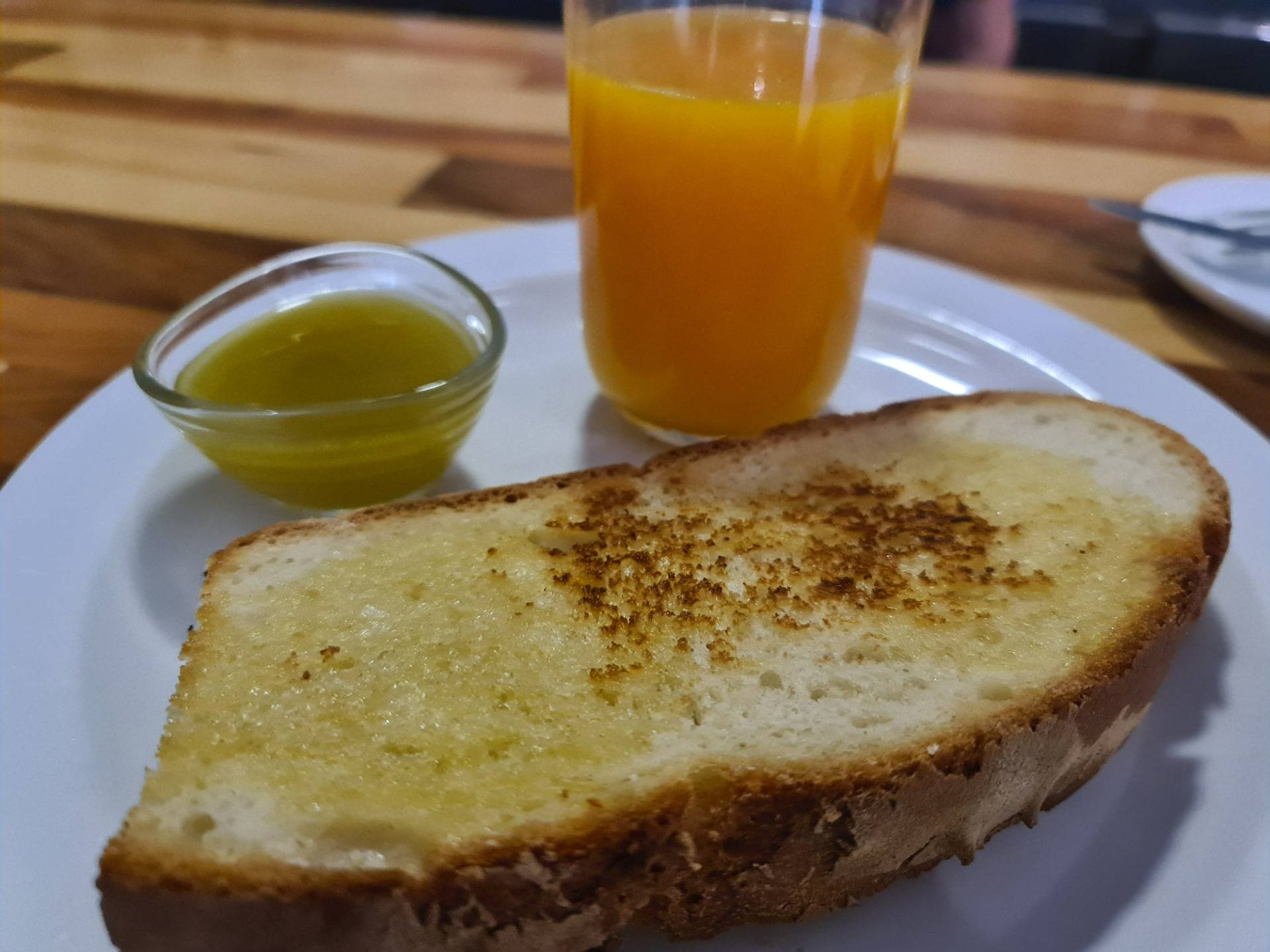 Toast with artisan village bread, artisan butter, homemade plum jam and freshly squeezed orange juice.