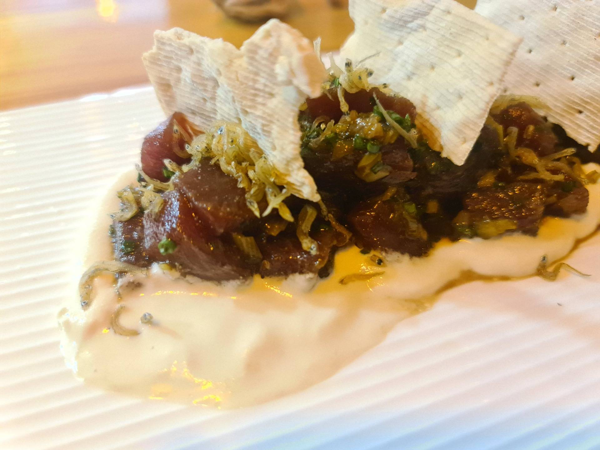 Bluefin tuna tartare on garlic gazpacho cream topped with niboshi, poached onion on a sherry reduction and ”regañá” crackers (€18.50) (2).