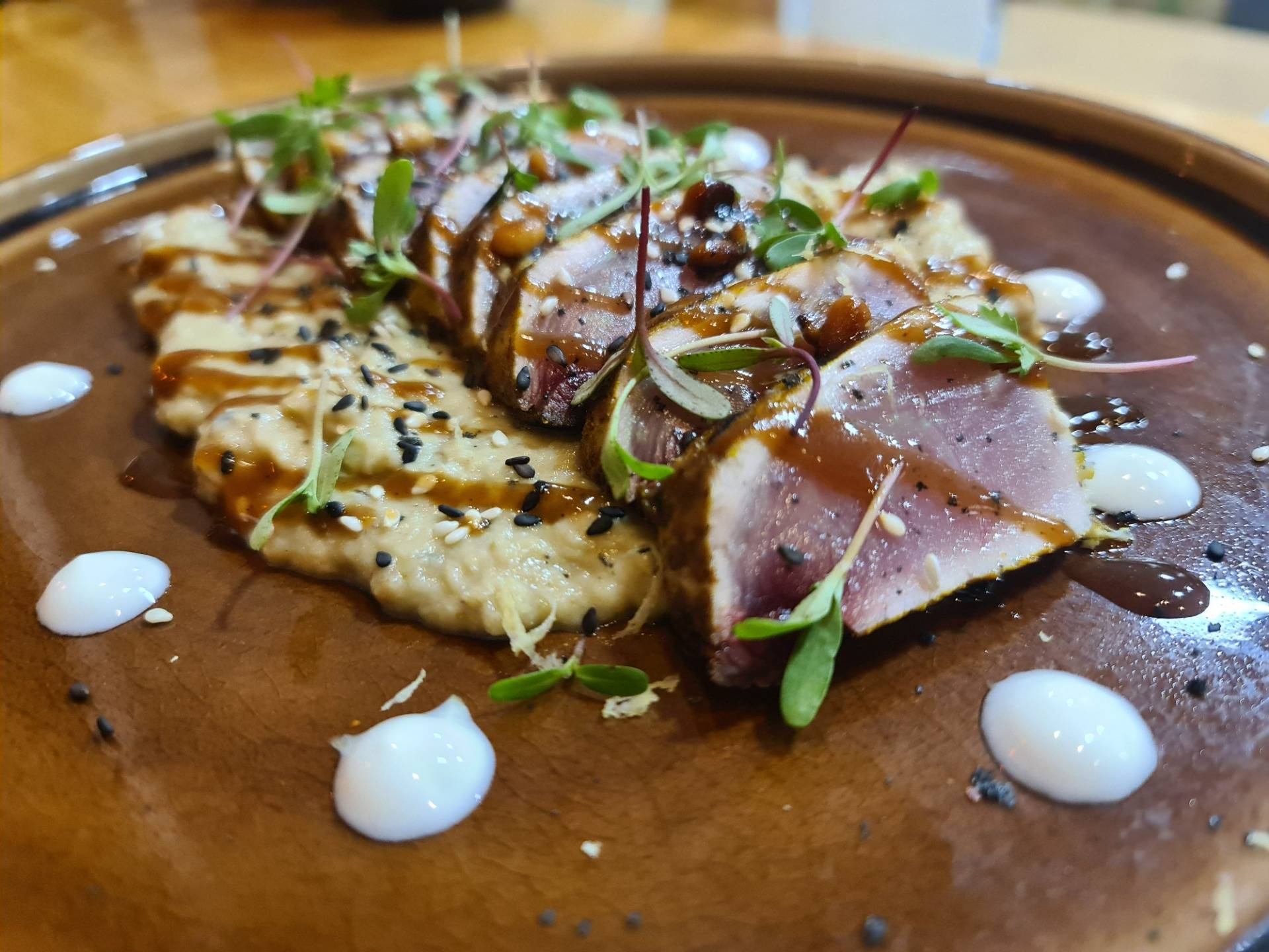 Lebanese style bonito (white tuna) marinated in ras-el-hanout and caraway on a Baba Ghanoush (Arabic eggplant paste) with pomegranate molasses, yogurt dots, tangerine sprouts and pine nuts (€21.50) (2).