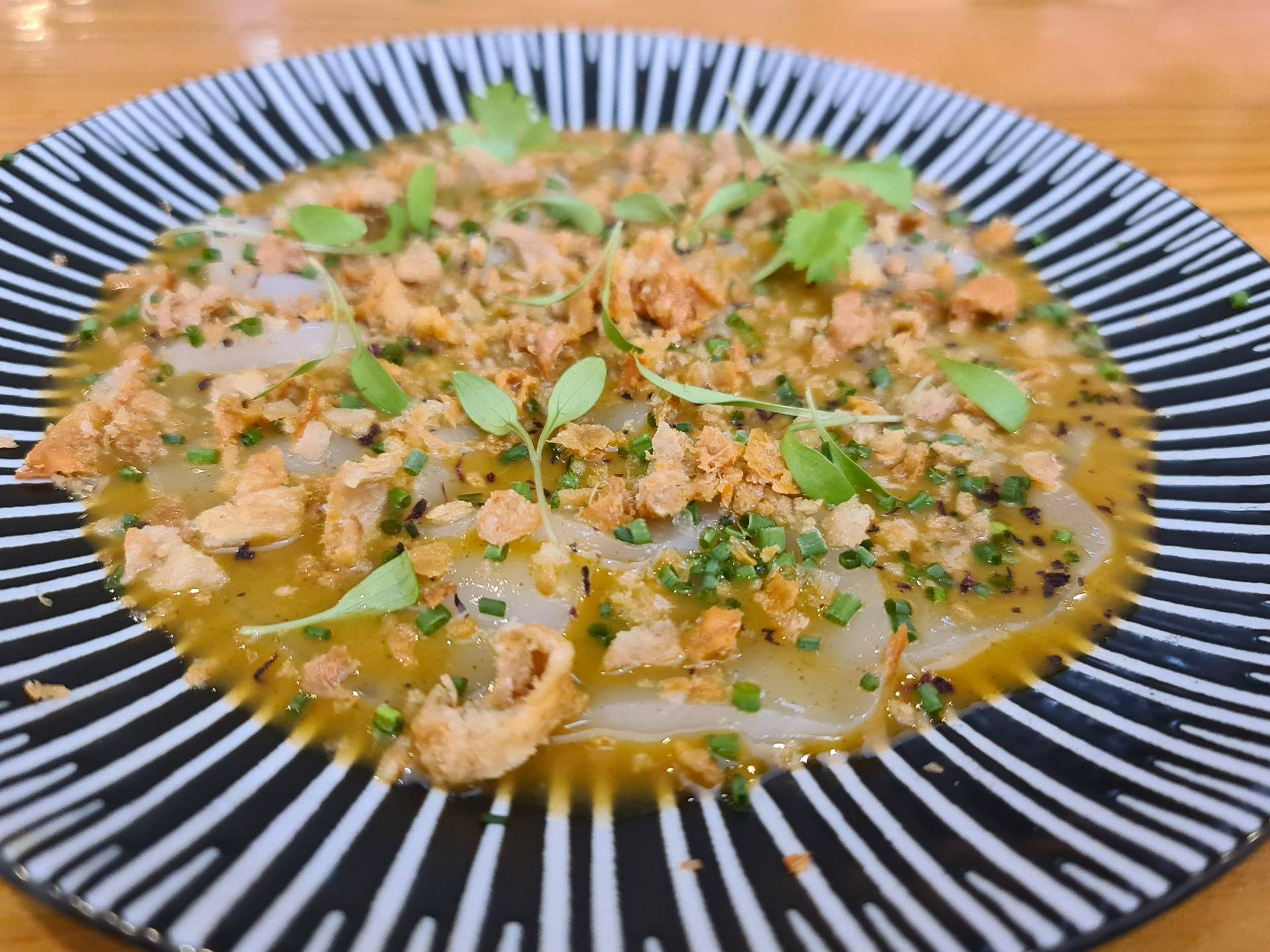 ”Thai style scallop usuzukuri” (special scallop sashimi cut on a homemade version of fish sauce, oyster sauce, brown sugar and tamarind sauce with fried chicken skin crumbs topping (€24) (1).