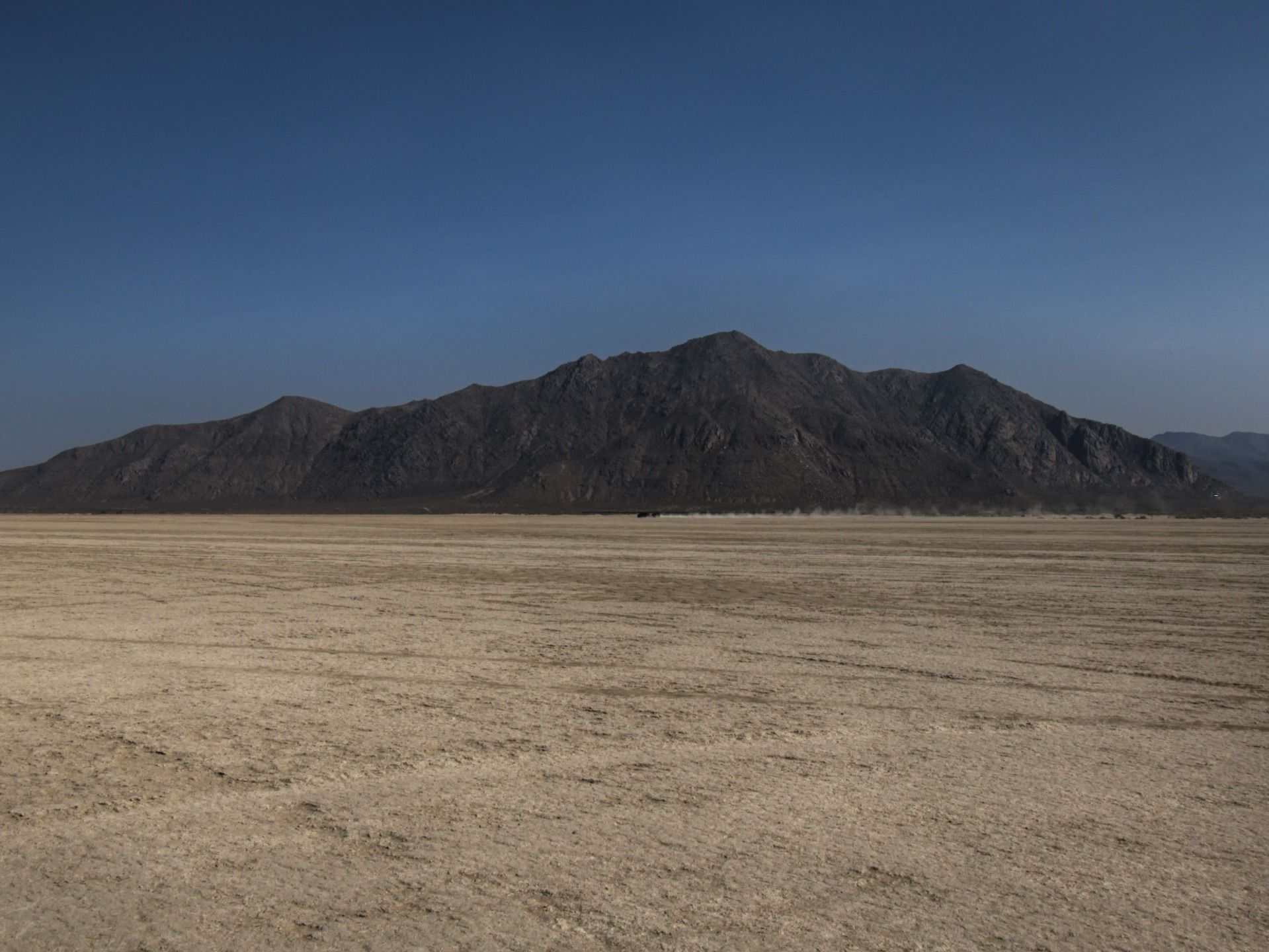 Old Sawtooth Mountain. Jungo Road and Trego Hot Springs are located at the base of the mountain. A Jeep and RV just finished making their way over Trego Siding. People were using this route to access the playa all day.