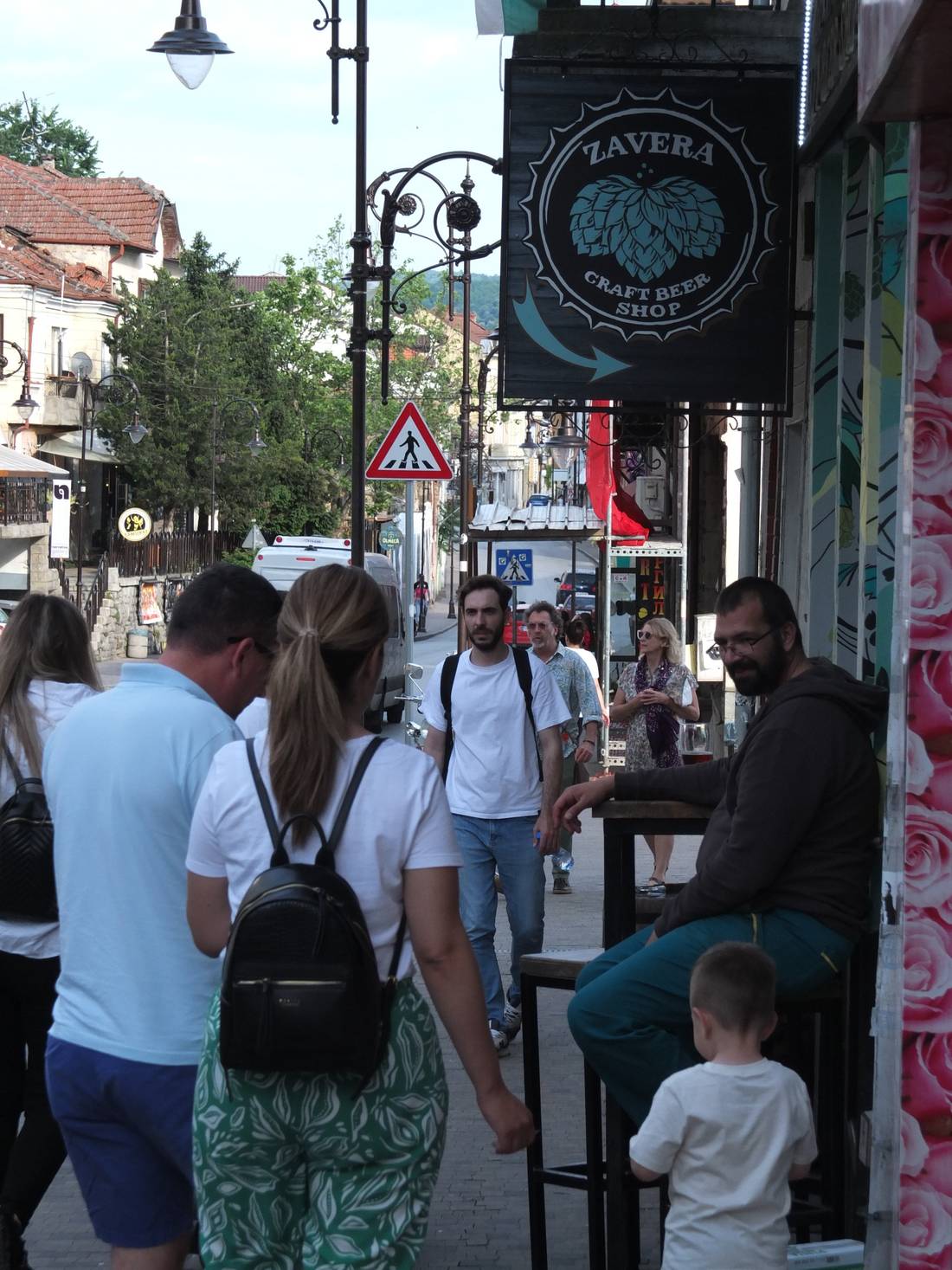 Busy streets of Veliko Tarnovo being monitored by a chilled looking guy enjoying his craft beer.